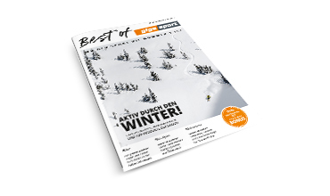 Magazincover mit dem Titel „Best of INTERSPORT“ zeigt eine verschneite Landschaft mit kleinen Bäumen. Rechts ist ein Skifahrer zu sehen. Deutscher Text wirbt für Winteraktivitäten. Orangefarbener runder Aufkleber unten rechts.