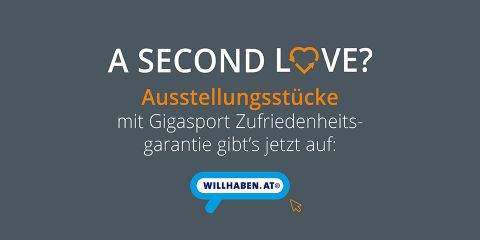 Text auf dunklem Hintergrund mit Herzsymbol in „LOVE“: „A SECOND LOVE? Ausstellungsstücke mit Gigasport Zufriedenheitsgarantie gibt's jetzt auf: willhaben.at“.