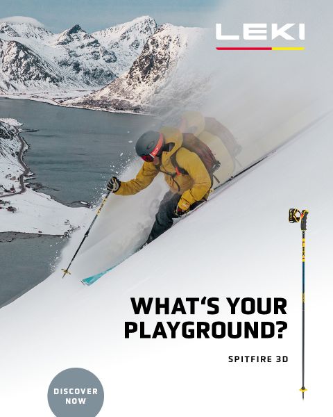 Ein Skifahrer in gelber Jacke und Skibrille fährt mit Stöcken einen verschneiten Berghang hinunter. Im Hintergrund sind schneebedeckte Berge und ein See zu sehen. Der Text lautet „WAS IST DEIN SPIELPLATZ? SPITFIRE 3D“ mit einem „JETZT ENTDECKEN“-Button.