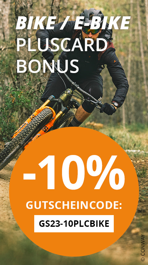 Mountainbiker fährt auf einem Feldweg in einem Wald. Textüberlagerung bietet 10 % Rabatt auf Fahrräder/E-Bikes mit dem Code GS23-10PLCBIKE. Der Text „PLUSCARD BONUS“ ist ebenfalls sichtbar. Der Biker trägt ein dunkles Outfit und einen Helm.
