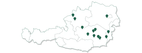 Karte von Österreich mit grünen Standortmarkierungen in den zentralen und östlichen Regionen. Der schwarze Hintergrund betont die weiße Karte und die Markierungen.