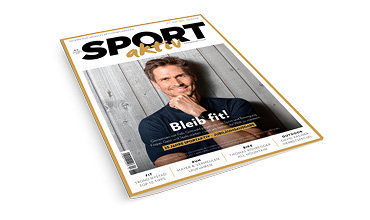 Eine deutsche Zeitschrift mit dem Titel "Sport aktiv" mit einem lächelnden Mann in einem dunklen Hemd auf dem Cover, der an einer Holzwand steht. Die Hauptüberschrift lautet "Bleib fit!" in fetten weißen Buchstaben.