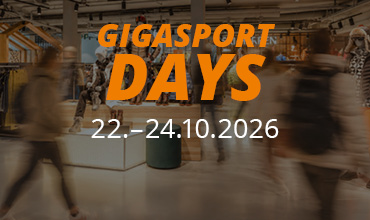 „GIGASPORT DAYS“ – Textüberlagerung auf einem unscharfen Bild von Kunden in einem Einzelhandelsgeschäft.